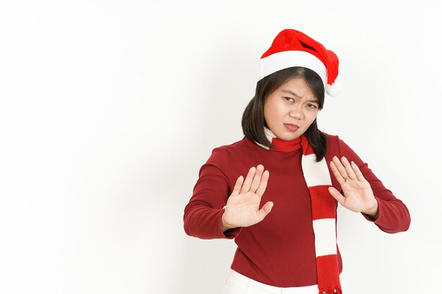 Stop Hand Gesture of Beautiful Asian Woman Wearing Red Turtleneck and Santa Hat Isolated On White