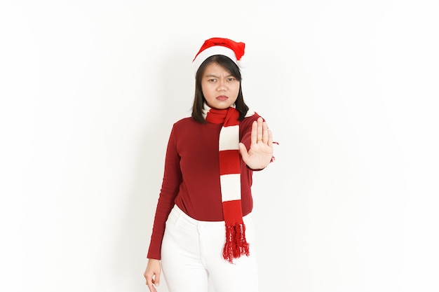 Stop Hand Gesture of Beautiful Asian Woman Wearing Red Turtleneck and Santa Hat Isolated On White