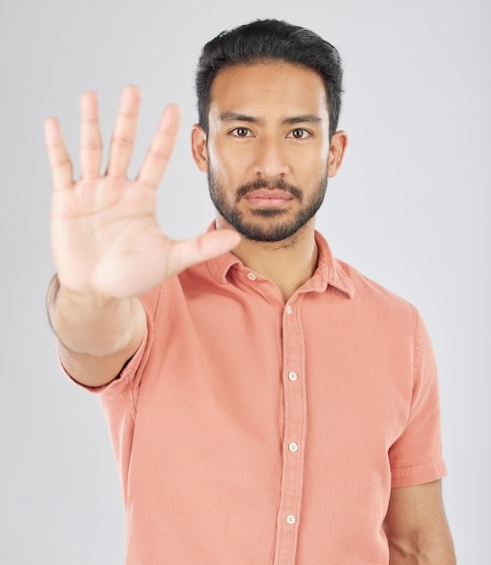 Photo stop hand and portrait of asian man in studio with warning control or protection order on grey background protest palm and face of japanese male model with no emoji and limit ban or threat sign