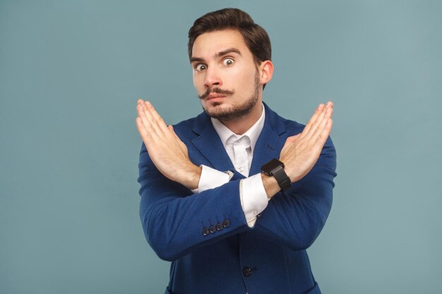 Stop no businessman showing hand ban at camera