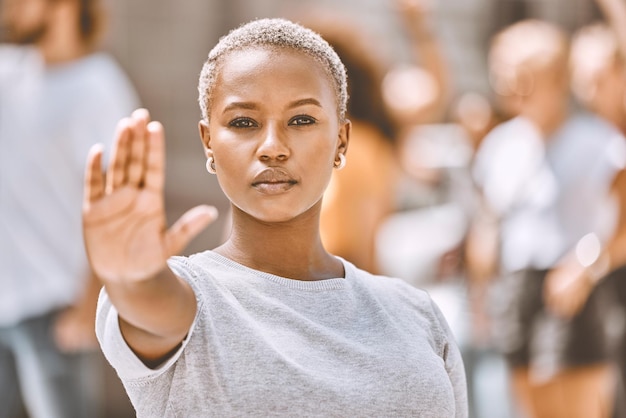 Fermare la protesta e la mano della donna di colore in città per l'attivismo giustizia sociale o emancipazione libertà della giustizia e sostegno con la ragazza no o segno di cautela per il cambiamento globale diritti umani o uguaglianza di genere