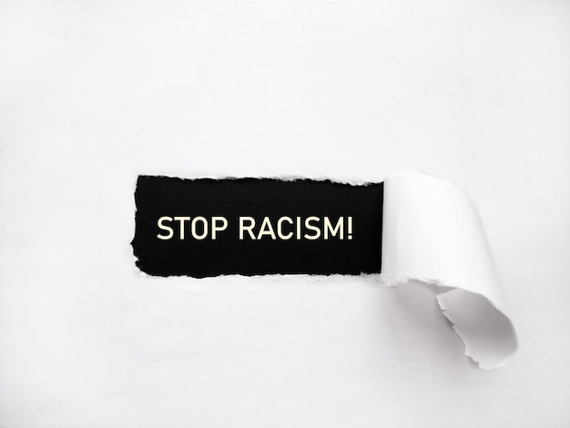 Stop racism. Writing on torn paper.