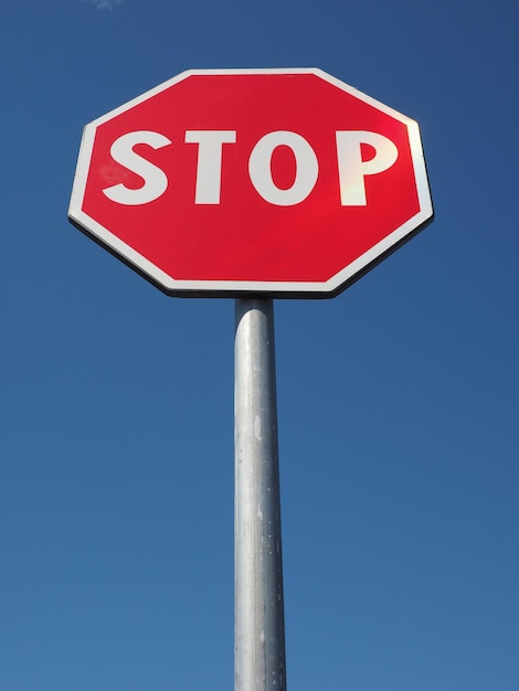 Stop sign over blue sky