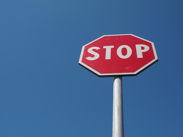 Stop sign over blue sky