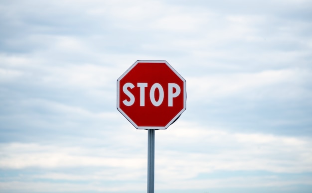 stop sign on cloudy sky