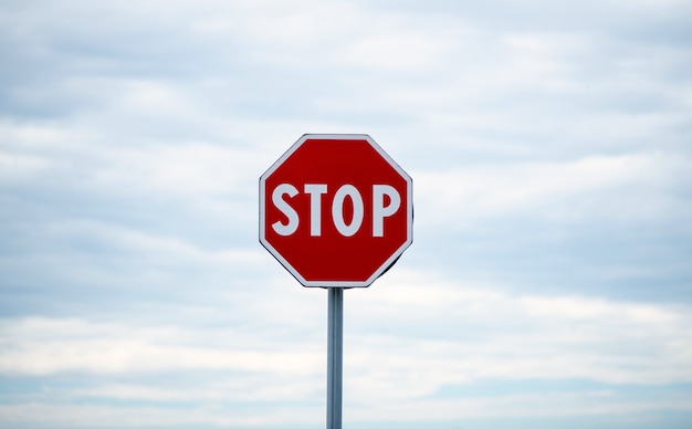 Photo stop sign on cloudy sky