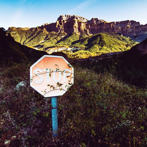 Photo stop sign with mountains in the background