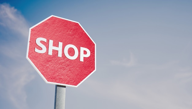 STOP sign with the word SHOP concept of business and stores