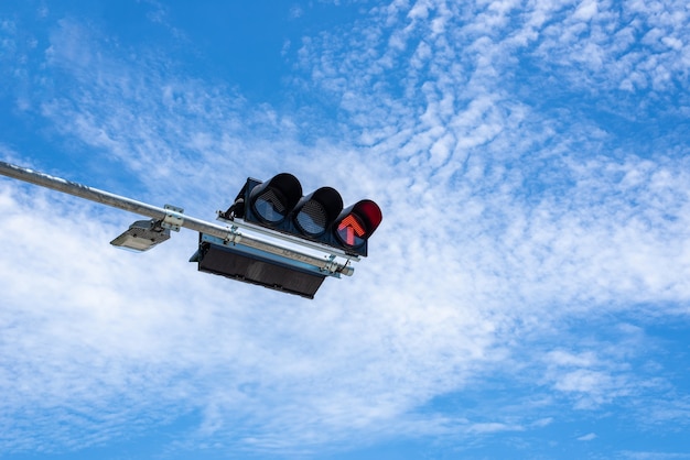 Stop signal for traffic light on the road with blue sky and clouds