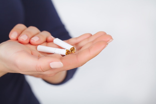 Stop Smoking. Beautiful Woman Breaking Cigarette In Half