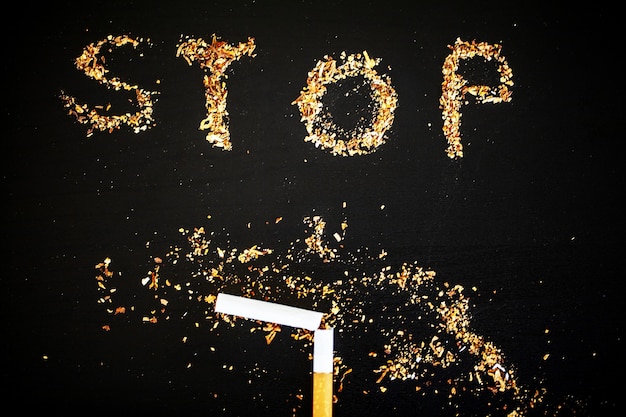 Stop smoking concept on background with broken cigarettes