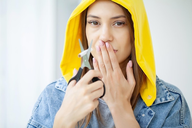 Stop smoking, woman cuts a cigarette with scissors.