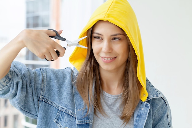 Stop smoking, woman cuts a cigarette with scissors.