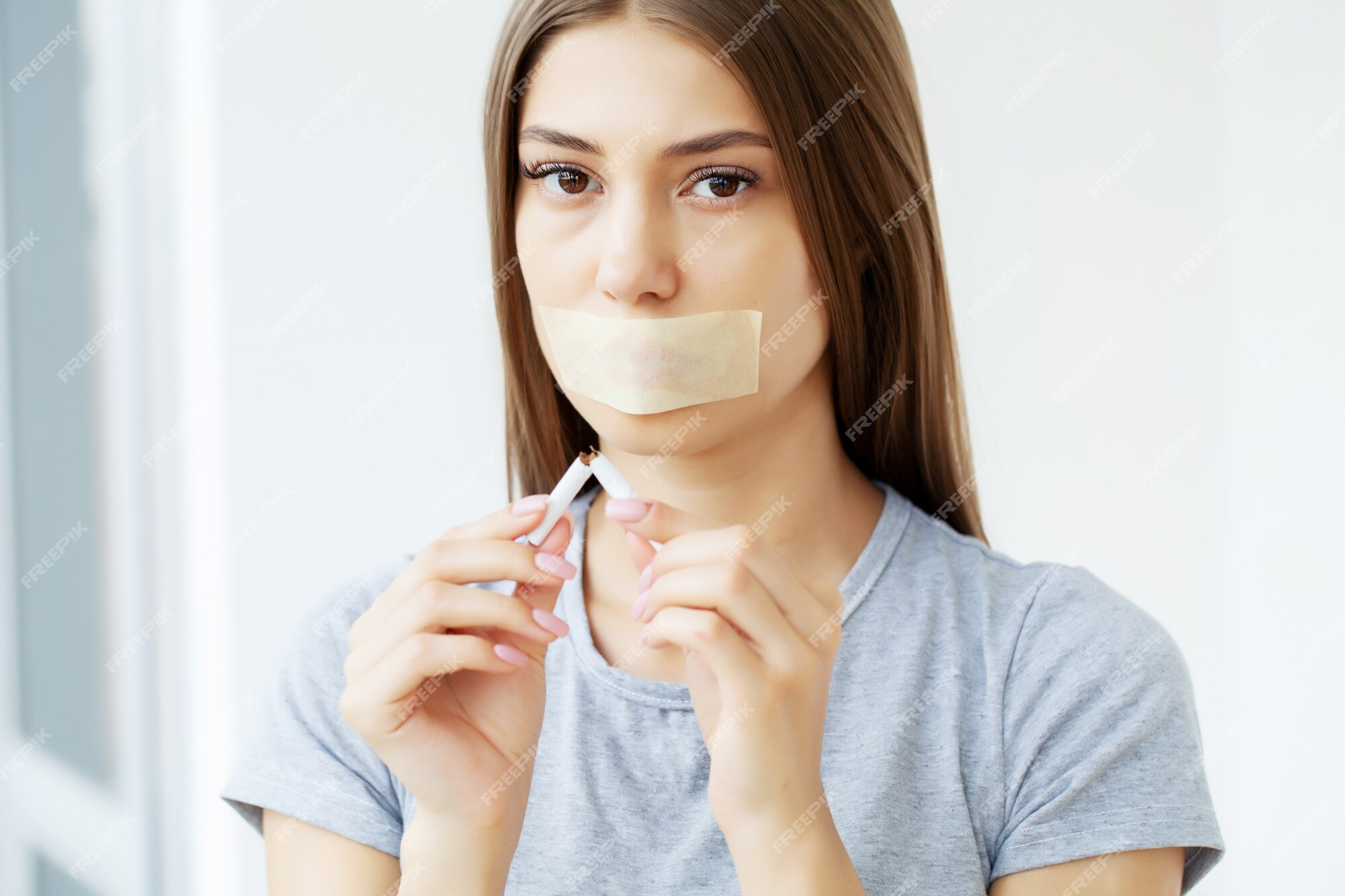 Premium Photo | Stop smoking, a young woman with a sealed mouth draws attention to the harmful effects of smoking on health Premium Photo | Stop smoking, a young woman with a sealed mouth draws attention to the harmful effects of smoking on health