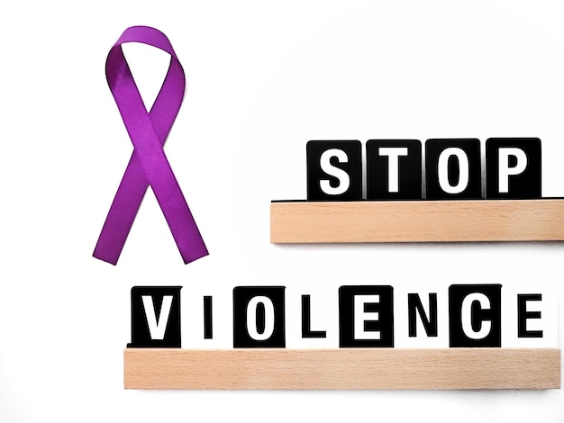 Photo stop violence against women background with text and purple ribbon
