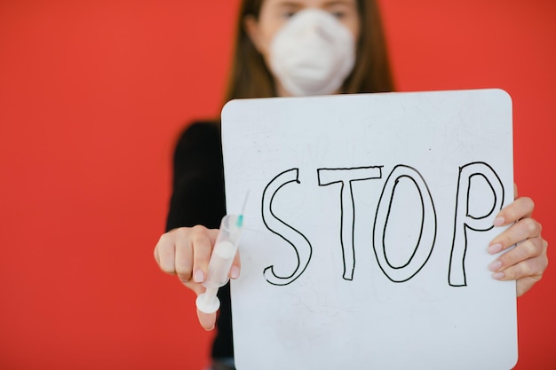 stop the virus and epidemic diseases healthy woman in medical protective mask showing gesture stop
