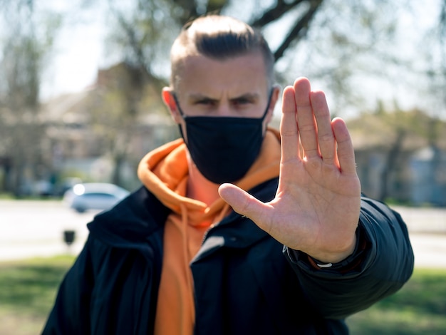 Stop virus. Man in black protective mask