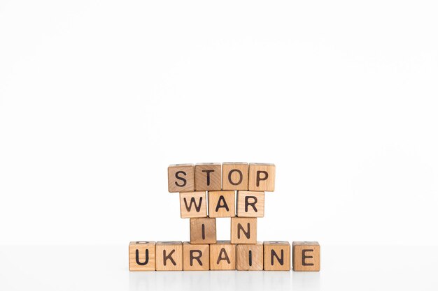 Stop war in Ukraine words written on wood block Text on table concept