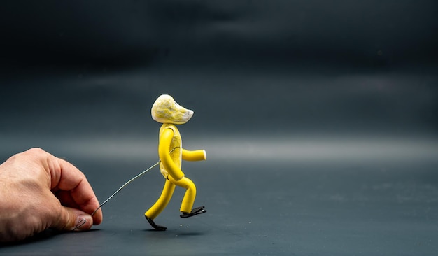 Stopmotion process of walking Fifth step Man's hand holding with an aluminum wire a figure