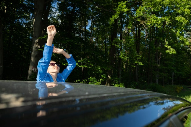 A stopover in the forest on the side of the road during long journeys by passenger car for a dream vacation