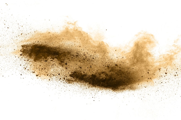 Photo stopping the movement of brown powder. explosive brown powder on white background.