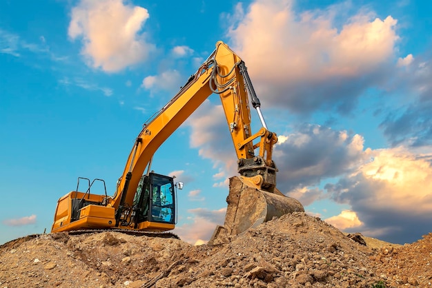 A stopping yellow excavator at stunning fluffy clouds