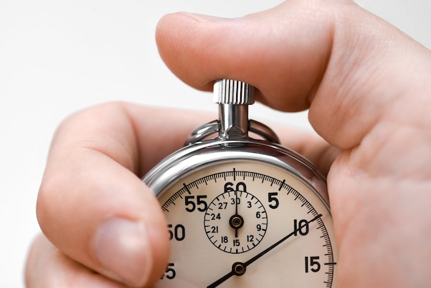 Photo stopwatch button presses hand finger on white background, isolate.