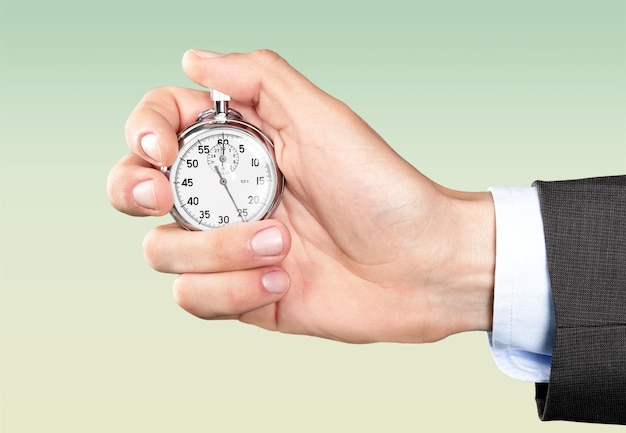 Stopwatch in Human Hand on light background