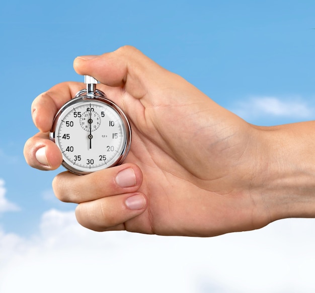 Stopwatch in Human Hand on light background