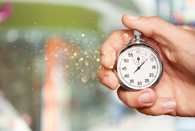 Measuring The Running Speed Of An Athlete Using A Mechanical Stopwatch Hand  With A Stopwatch On The Background Of The Legs Of A Runner Stock Photo -  Download Image Now - iStock