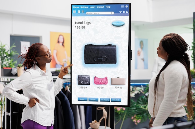 Photo store assistant showing items to woman