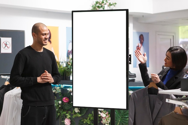 Photo store employee pointing at empty board