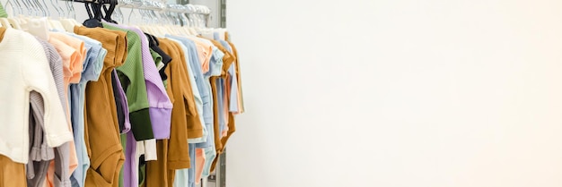 Store rack with children's clothes Clothes Rail with cotton clothes for babies selective focus