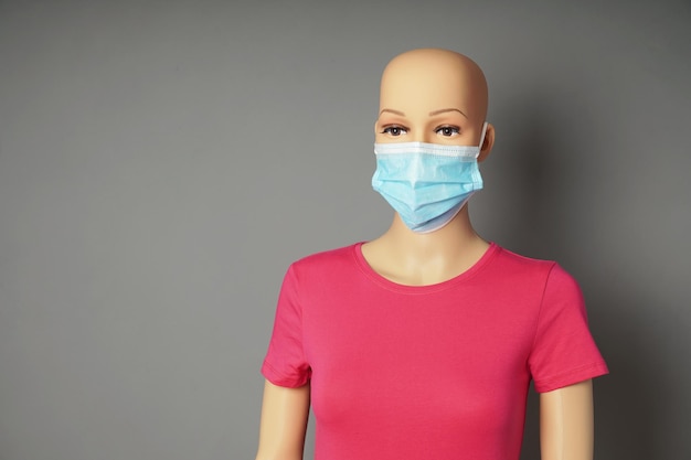 Store window mannequin or display dummy wearing medical face mask