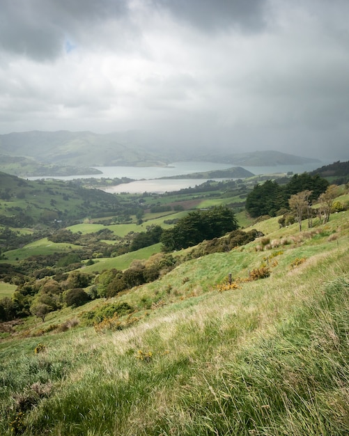 Storm approaching a valley with green rolling hills banks peninsula new zealand