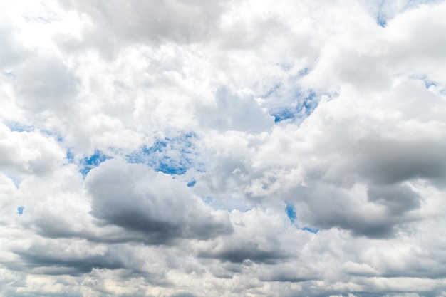 Storm clouds floating in a rainy day with natural light Cloudscape scenery overcast weather above blue sky White and grey cloud scenic nature environment background