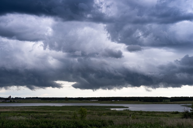 Photo storm clouds over the lake. rainy season.