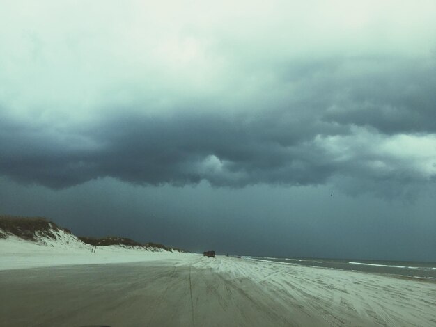 Storm clouds over snow covered landscape