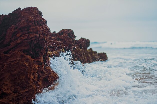 Storm in the ocean sea waves crashing on rocks on the beach coast nature and waterscape