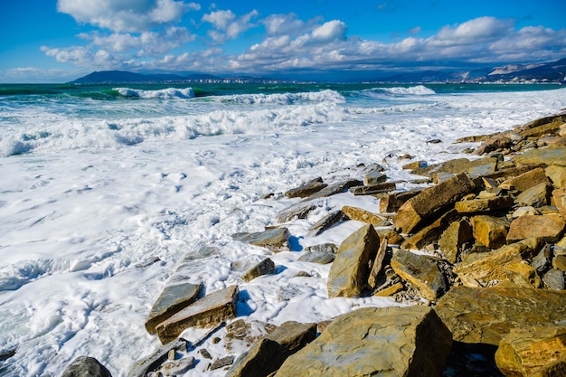 Storm in Tsemesskaya Bay Turquoise waves with beautiful snowwhite foam fall on Cape Doob