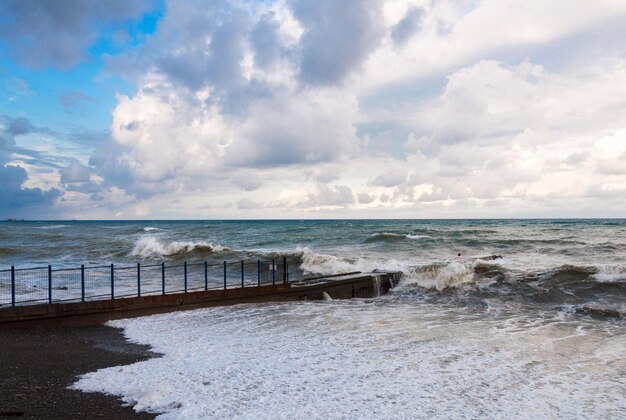 Storm waves roll on the breakwater