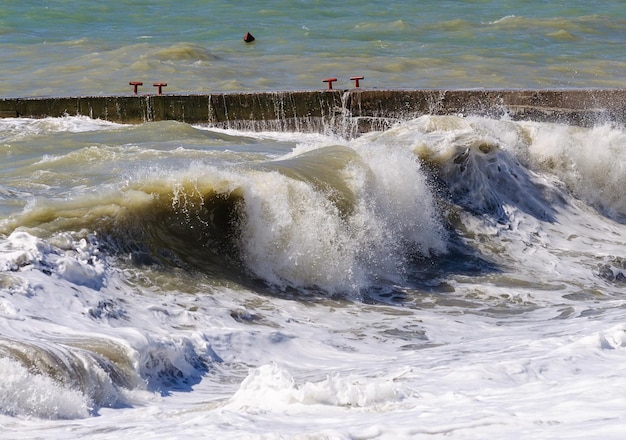 Storm waves roll on the breakwater