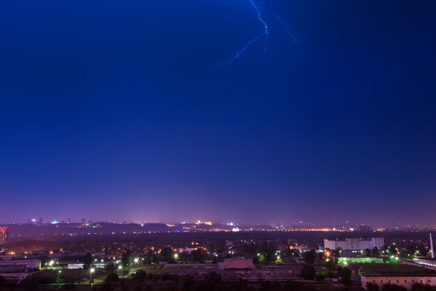 Storm with lightning in the city. Dark night dramatic sky with clouds