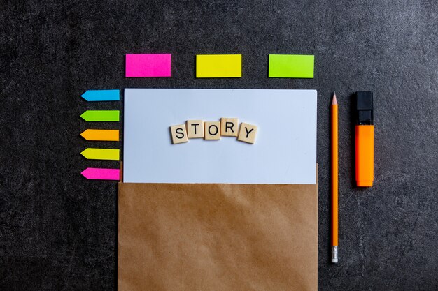 Story letters on paper sheet and notes around on a table