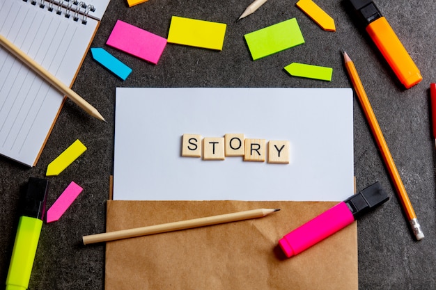 Story letters on paper sheet and notes around on a table