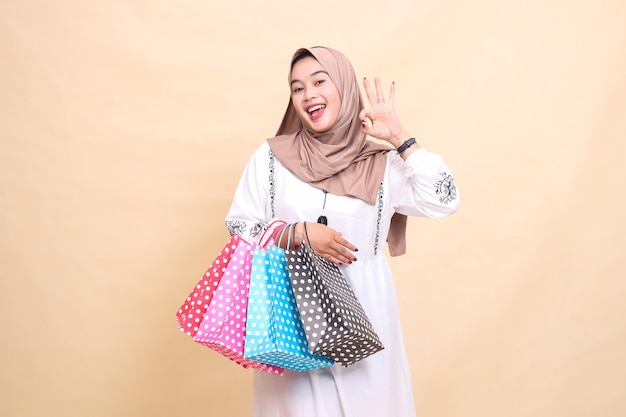 история молодой индонезийской мусульманки в хиджабе с счастливым выражением лица, жестикулирующей и несущей
