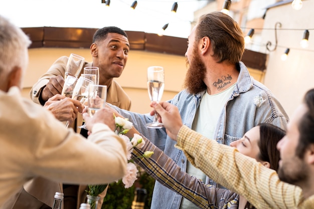 Storytelling footage of a multiethnic group of people dining on a rooftop. Family and friends make a reunion at home