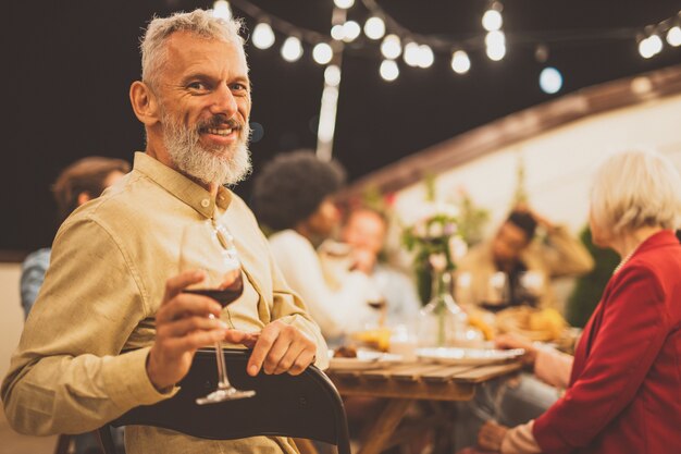 Storytelling footage of a multiethnic group of people dining on a rooftop. Family and friends make a reunion at home