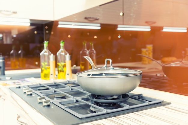 Stove with pan on the plastic modern kitchen