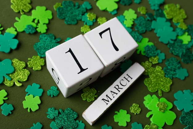StPatrick 's Day March Calendar with holiday decor on green background Flat lay Top view 17 march